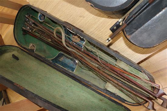 Three half size violins, a quantity of bows and six violin cases